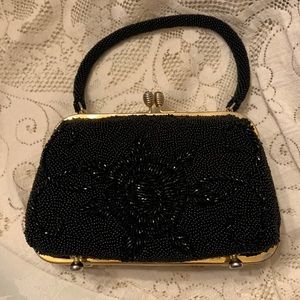 Black vintage clutch  bag with two stone clear/ yellow on the latch.